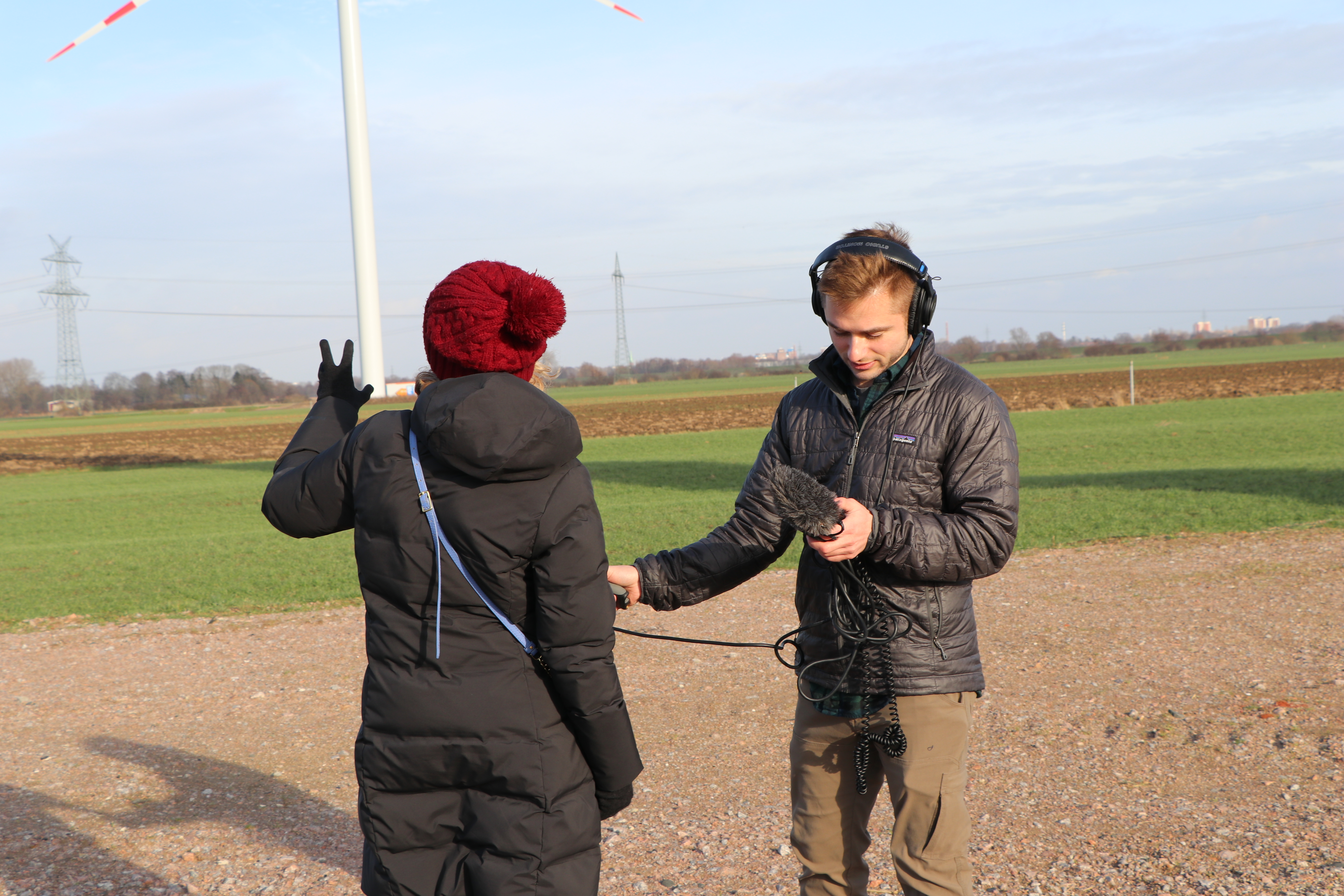 Grant Schwab reporting in the field near wind turbines